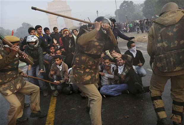 A protester throws a piece of wood at Indian police during a violent demonstration near the India Gate against a gang rape and brutal beating of a 23-year-old student on a bus last week, in New Delhi, India, Sunday, Dec. 23, 2012. The attack last Sunday has sparked days of protests across the country. (AP Photo)