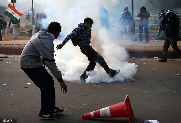 A protestor kicks a teargas canister during a violent demonstration near the India Gate against a gang rape and brutal beating of a 23-year-old student on a bus last week, in New Delhi, India, Sunday, Dec. 23, 2012. The attack last Sunday has sparked days of protests across the country. (AP Photo/Saurabh Das)