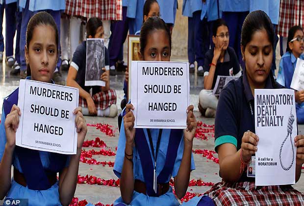 Indian schoolgirls hold placards during a prayer ceremony to mourn the death of a 23-year-old gang rape victim, at a school in Ahmadabad, India, Saturday, Dec. 29, 2012. Shocked Indians on Saturday were mourning the death of the woman who was gang-raped and beaten on a bus in New Delhi nearly two weeks ago in an ordeal that galvanized people to demand greater protection for women from sexual violence. (AP Photo/Ajit Solanki)