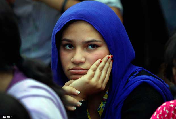 An Indian student listens to a speaker as she participates in a protest to mourn the death of a 23-year-old gang rape victim, in Bangalore, India, Saturday, Dec. 29, 2012. (AP Photo/Aijaz Rahi)