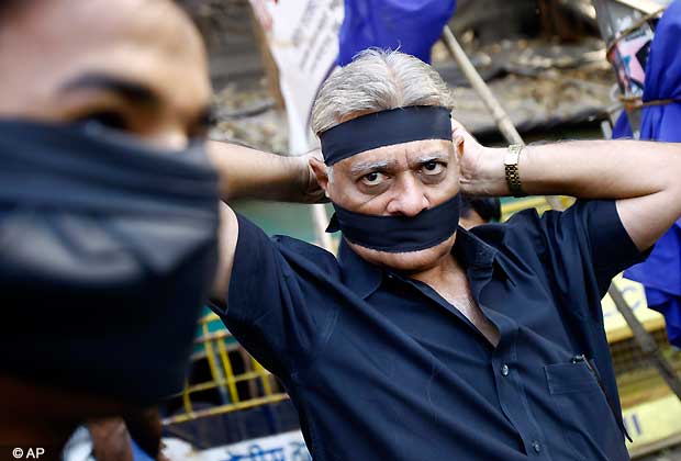 An Indian ties a black band as he arrives to attend a gathering to mourn the death of a 23-year-old gang rape victim, in Mumbai, India, Saturday, Dec. 29, 2012. Shocked Indians on Saturday were mourning the death of the woman who was gang-raped and beaten on a bus in New Delhi nearly two weeks ago in an ordeal that galvanized people to demand greater protection for women from sexual violence. (AP Photo/Rafiq Maqbool)