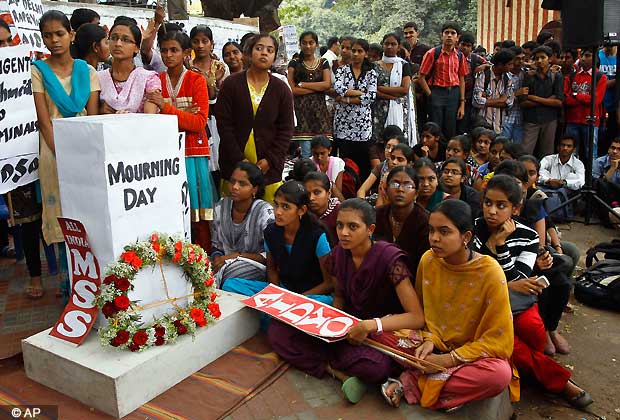 Indians gather next to a makeshift memorial to mourn the death of a 23-year-old gang rape victim, in Bangalore, India , Saturday, Dec. 29, 2012. (AP Photo/Aijaz Rahi)