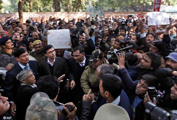 Chief Minister of Delhi state Sheila Dikshit, front left, gestures to pacify agitated protesters heckling her when she came to express her sympathy with them after the death a gang rape victim in New Delhi, India, Saturday, Dec. 29, 2012. (AP Photo/Altaf Qadri)