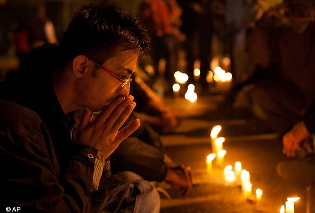 An Indian participates in a candle-lit vigil to mourn the death of a gang rape victim in New Delhi, India, Saturday, Dec. 29, 2012.  (AP Photo/ Dar Yasin)