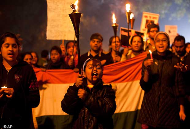A young Indian girl leads a protest march while holding torches as they mourn the death of a gang rape victim in New Delhi, India, Saturday, Dec. 29, 2012. Indian police charged six men with murder on Saturday, adding to accusations that they beat and gang-raped the woman on a New Delhi bus nearly two weeks ago in a case that shocked the country. The murder charges were laid after the woman died earlier Saturday in a Singapore hospital where she has been flown for treatment.(AP Photo/ Dar Yasin)