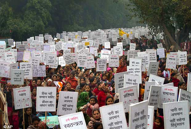 Indian women carry placards as they march to mourn the death of a gang rape victim in New Delhi, India, Wednesday, Jan. 2, 2013.  The banners read 