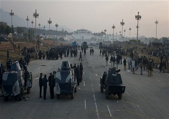 Pakistani police, in armored vehicles, and riot officers gather to deal with any violence as supporters of Pakistan Sunni Muslim cleric Tahir-ul-Qadri hold an anti-government rally in Islamabad, Pakistan on Tuesday, Jan. 15, 2013.(AP Photo)