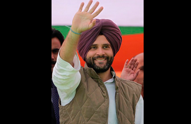 FILE - In this Jan. 25, 2012 file photo, India's ruling Congress party leader Rahul Gandhi, wearing a Sikh turban presented to him, waves at supporters during an election rally in Chabal, about 30 kilometers (19 miles) from Amritsar, India. Gandhi was appointed Vice President of the party at a special two-day long party seminar on Saturday, Jan. 19, 2013. (AP Photo/Altaf Qadri, File)