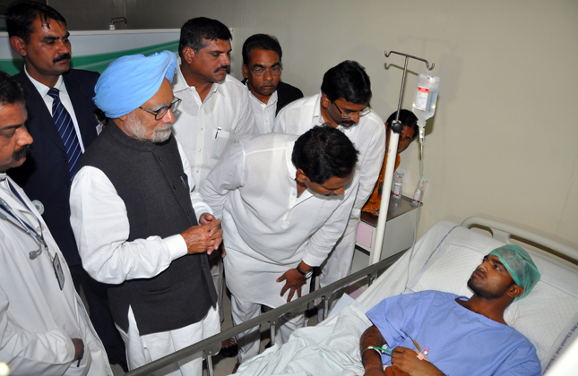 Prime MInister Manmohan Singh accompanied by Andhra Pradesh Chief MInister N.Kiran Kumar Reddy is seen consoling the victims of bomb blast at Yashoda Hospital in Hyderabad on Feb. 24, 2013. Sri ESL Narasimhan,H.E. Governor of AP., Smt.P.Sabitha Reddy, Minister for Home and other Dignitaries are also seen. (Photo: IANS)