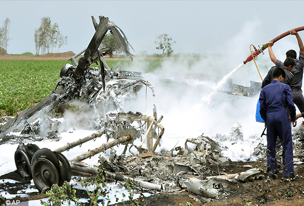 Indian Air Force (IAF) personnel spray foam into the wreckage after two air force helicopters collided and crashed at a field in Sarmat village, near Jamnagar in Gujarat, Thursday, Aug. 30, 2012. According to an IAF spokesman the two Russian made Mil MI 17 helicopters were on a routine training sortie when they collided and crashed killing all eight airmen aboard. (AP Photo)