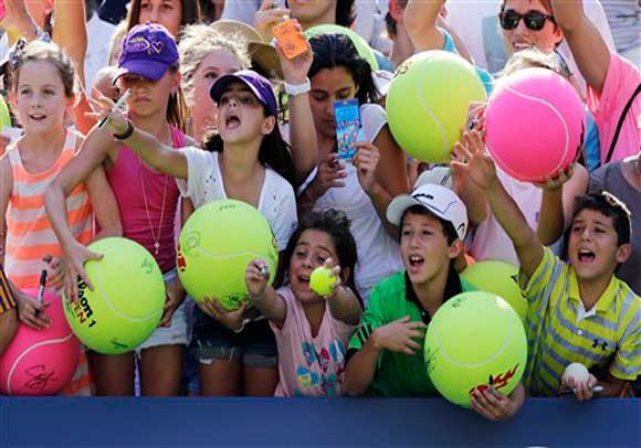 Young tennis fans try to get autographs from Maria Sharapova, of Russia, after winning her match against Mallory Burdette in the third round of play at the 2012 US Open tennis tournament, Friday, Aug. 31, 2012, in New York. (AP Photo/Mike Groll)