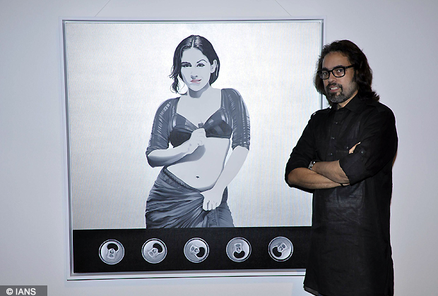 A person stands near Vidya Balan's portrait at Andy Pop inspired painting exhibition in Colaba Causeway, Mumbai on Saturday. (Photo IANS)