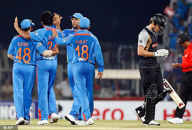 Indian cricketer Yuvraj Singh, center facing camera, and teammates celebrate the dismissal of New Zealand's Rob Nicol, right, during the second and final Twenty20 international cricket match between India and New Zealand in Chennai, India, Tuesday, Sept. 11, 2012. Allrounder Yuvraj Singh makes his return to international cricket after fighting a rare germ cell cancer near his lungs. (AP Photo)