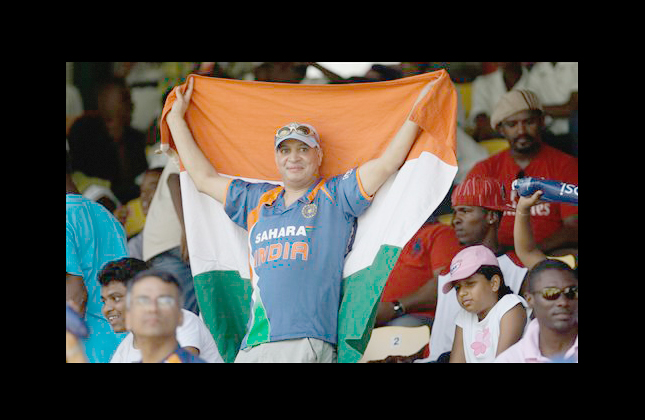 A fan of India's cricket team holds an Indian flag during a Twenty20 Cricket World Cup match between India and South Africa in Gros Islet, St. Lucia, Sunday, May 2, 2010. (AP Photo/Aijaz Rahi)