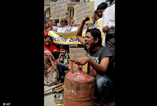 Indians shouts slogans during a protest against price hike in diesel and capping the number of subsidized cooking gas cylinders at six a year, in Ahmadabad, India, Friday, Sept. 14, 2012. (AP Photo/Ajit Solanki)