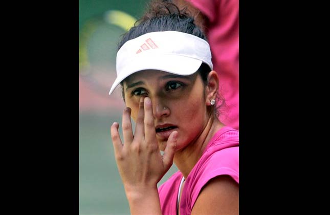 Indian tennis star Sania Mirza reacts during a warm up session in Hyderabad, India, Thursday, May 6, 2010.AP Photo