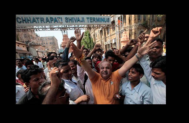 People celebrate after a court in India handed a death sentence to Pakistani Mohammed Ajmal Kasab, the only surviving gunman in the bloody 2008 Mumbai attacks, near the Chhatrapati Shivaji Terminal, one of the sites of the terror attacks, in Mumbai, India, Thursday, May 6, 2010. (AP Photo/Rajanish Kakade)