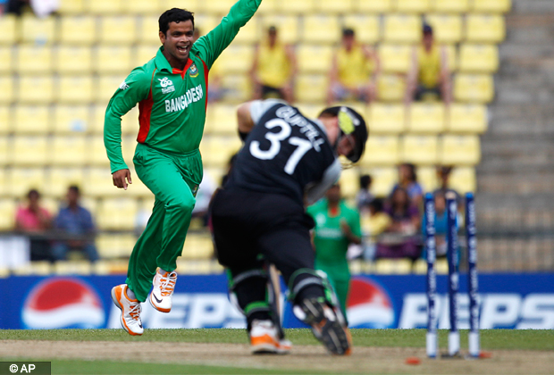 Bangladesh's bowler Abdur Razzak, left, celebrates after taking the wicket of New Zealand batsman Martin Guptill, right, during their ICC Twenty20 Cricket World Cup match in Pallekele, Sri Lanka, Friday, Sept. 21, 2012. (AP Photo/Aijaz Rahi)