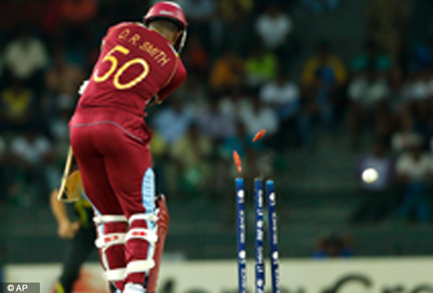 West Indies' batsman Dwayne Smith is bowled out by Australia's Mitchell Starc, unseen, during their ICC Twenty20 Cricket World Cup match in Colombo, Sri Lanka, Saturday, Sept. 22, 2012 . (AP Photo/Eranga Jayawardena)