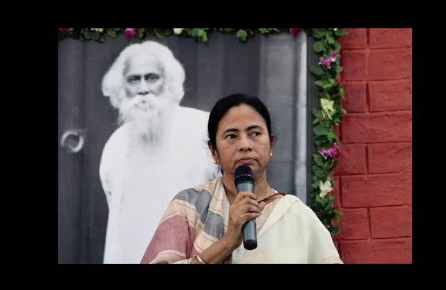 Indian Railway Minister Mamata Banerjee, right, backdropped by Nobel laureate Rabindranath Tagore's portrait, is seen during the inauguration of an exhibition train to commemorate the 150th birth anniversary of Tagore, in Calcutta, India, Sunday, May 9, 2010. Events across India marked the 150th birth anniversary of freedom poet Tagore. (AP Photo/Bikas Das)