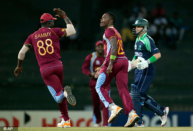 West Indies' bowler Fidel Edwards, center celebrates the dismissal of Ireland's captain William Porterfield, right during the ICC Twenty20 Cricket World Cup match between Ireland and West Indies, in Colombo, Sri Lanka, Monday, Sept. 24, 2012. (AP Photo/Gemunu Amarasinghe)