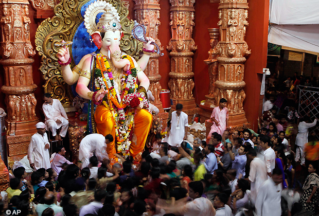 Devotees gather around an idol of Hindu God Ganesha in Mumbai, India, Friday, Sept. 28, 2012. The ten day Ganesh Chaturthi festival, dedicated to the worship of Ganesha, ends Saturday. (AP Photo)