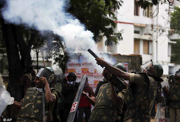 Police fire tear gas shells at students during a protest demanding the creation of a new state named 'Telangana' in Hyderabad, Sunday, Sept. 30, 2012. The protesters have been demanding that the new state be carved from the existing Andhra Pradesh state. (AP Photo)