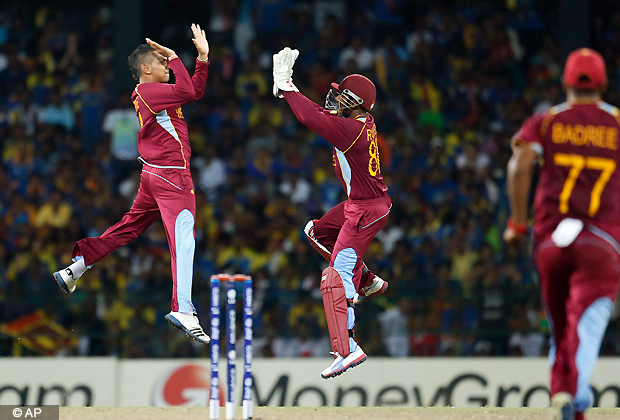 West Indies's bowler Sunil Narine, left, celebrates the dismissal of Sri Lanka's captain Mahela Jayawardena, unseen, with wicket keeper Denesh Ramdin, center during the ICC Twenty20 Cricket World Cup final match between Sri Lanka and West Indies in Colombo, Sri Lanka, Sunday, Oct. 7, 2012. (AP Photo/Gemunu Amarasinghe)