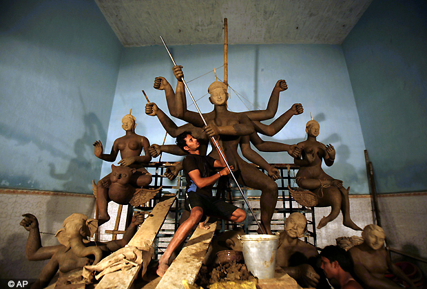 An artist works on an idol of Hindu Goddess Durga at a worship venue ahead of Durga Puja festival in Bhubaneswar, India, Wednesday, Oct. 10, 2012. (AP Photo)