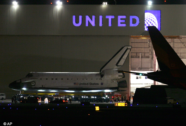 The space shuttle Endeavour is moved out of the United hangar at Los Angeles International Airport just before midnight Thursday, Oct. 11, 2012 to begin its two day trek across Los Angeles and Inglewood to the California Science Center where it will be on permanent display. (AP Photo/Los Angeles Times, Bryan Chan, Pool)