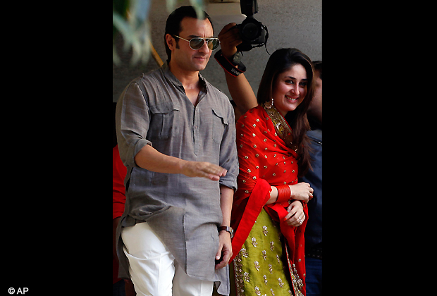 Bollywood stars Saif Ali Khan and Kareena Kapoor step out on a balcony to greet waiting fans after getting married in Mumbai, Tuesday, Oct. 16, 2012. The couple married Tuesday in a small official ceremony in Khan's house in Mumbai with a few friends and family members in attendance. (AP Photo)