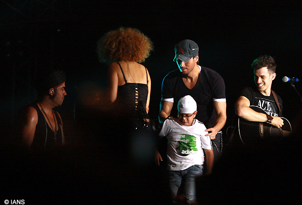 Enrique helps a young Indian Fan to get on stage with him in his live concert at Gurgaon. (Photo IANS/Amlan Paliwal)