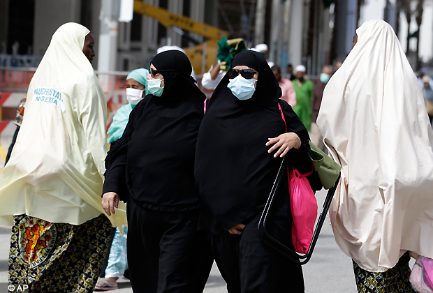 Muslim pilgrims leave the Grand mosque after noon prayer in Mecca, Saudi Arabia, Monday, Oct. 22, 2012. The annual Islamic pilgrimage draws three million visitors each year, making it the largest yearly gathering of people in the world. (AP Photo)