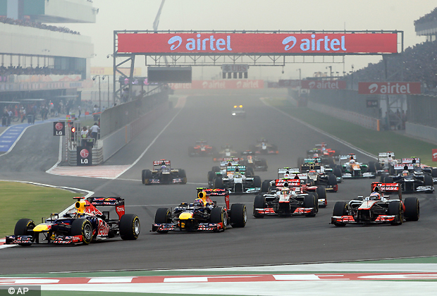 Red Bull driver Sebastian Vettel of Germany leads teammate Mark Webber of Australia into turn one at the start of the Indian Formula One Grand Prix at the Buddh International Circuit in Noida, Sunday, Oct. 28, 2012. (AP Photo)