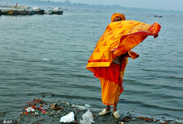 A Sadhu, or a Hindu holy man, returns after taking a dip in the River Ganges on Somvati Purnima or a full moon day that falls on a Monday at Sangam in Allahabad, India, Monday, Oct. 29, 2012. Allahabad on the confluence of the rivers Ganges and Yamuna is one of Hinduism's important centers. (AP Photo/Rajesh Kumar Singh)