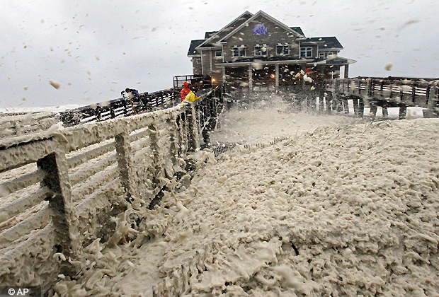 High winds blow sea foam onto Jeanette's Pier in Nags Head, N.C., Sunday, Oct. 28, 2012 as wind and rain from Hurricane Sandy move into the area. (AP Photo)