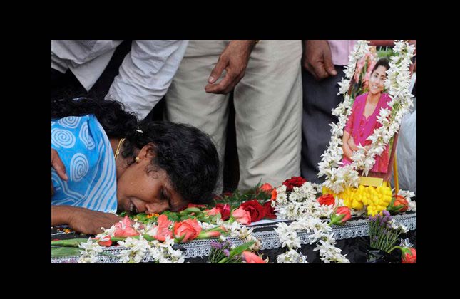 A relative breaks down near the coffin of one of the victims of Air India Express plane crash during a prayer meeting at a church in Mangalore, in the southern Indian state of Karnataka, Sunday, May 23, 2010. Investigators searching for clues as to what caused India's worst air disaster in more than a decade recovered the cockpit voice recorder and flight data recorder Sunday from the charred remains of an Air India flight.(AP Photo)