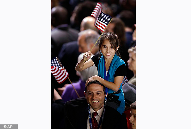 A young supporter waves a flag for President Barack Obama. (AP Photo/Chris Carlson)