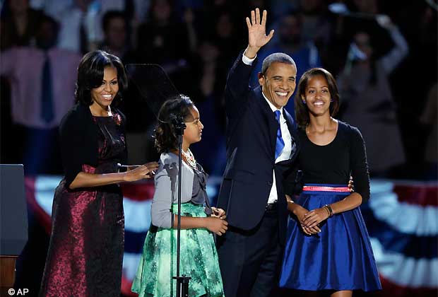 President Barack Obama waves as he walks on stage with first lady Michelle Obama and daughters Malia and Sasha at his election night party Wednesday, Nov. 7, 2012, in Chicago. President Obama defeated Republican challenger former Massachusetts Gov. Mitt Romney. (AP Photo)