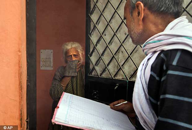 A Delhi Municipal field worker enquires about fumigation at an elderly woman's house before fumigation for prevention of dengue, in New Delhi, Nov. 8, 2012. Dengue cases in the capital rose to 1,277 on Wednesday, with 39 more people testing positive for the mosquito borne disease. (AP Photo)