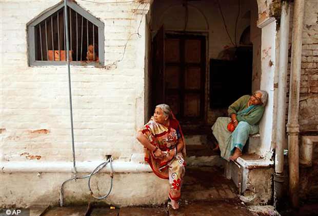 Women watch a religious procession ahead of Diwali, the Hindu festival of light, in Allahabad, Nov. 12, 2012. Diwali, the annual Hindu Festival of Light, will be celebrated on Nov. 13. (AP Photo)