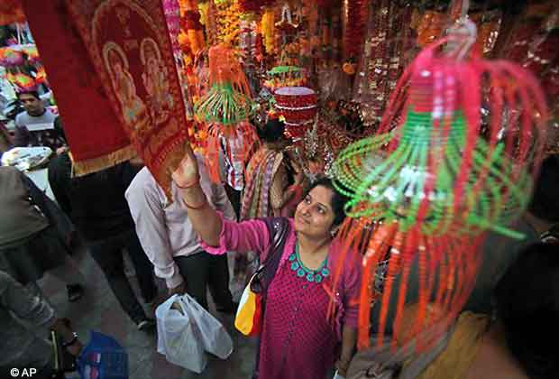 A woman shops on eve of Diwali in Jammu, Nov. 12, 2012. Diwali is marked by lighting lamps and offering prayers to the goddess of wealth Lakshmi, will be celebrated on Nov. 13. (AP Photo)