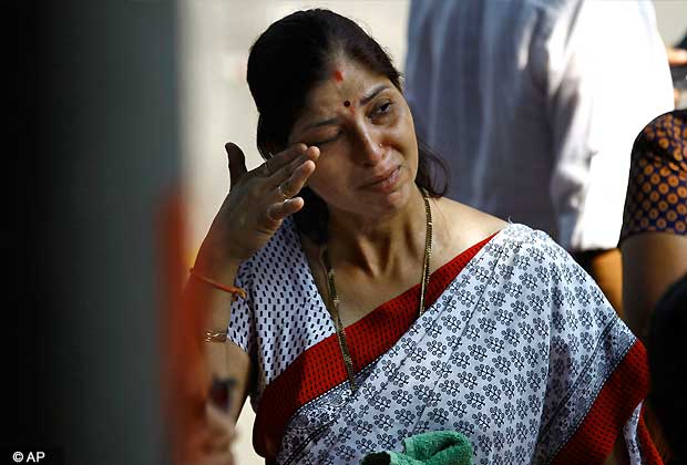 A supporter wipes her tears outside the house of Shiv Sena chief Bal Thackeray in Mumbai, Nov. 15, 2012. Thackery's health had worsened on Wednesday, leading to a surge of supporters in thousands outside his residence.(AP Photo)