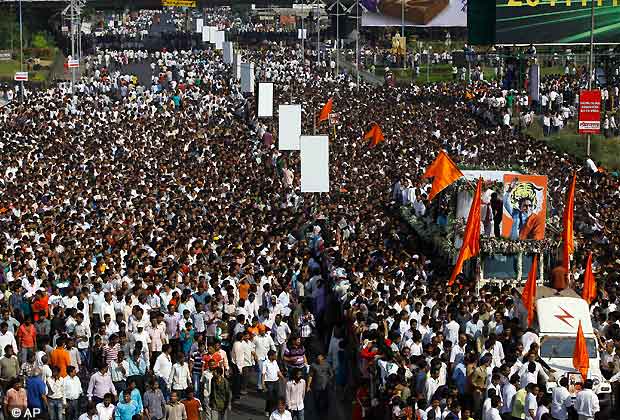 Mourners walk beside a truck carrying the body of Hindu hardline Shiv Sena party leader Bal Thackeray during his funeral in Mumbai, Nov. 18, 2012. (AP Photo)