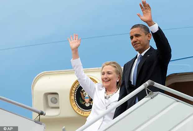 U.S. President Barack Obama and Secretary of State Hillary Rodham Clinton wave as they arrive at Yangon International Airport in Yangon, Myanmar, on Air Force One, Monday, Nov. 19, 2012. This is the first visit to Myanmar by a sitting U.S. president. (AP Photo/Carolyn Kaster)