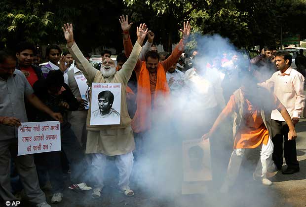 Activists of Bajarang dal shout slogans and burn firecrackers to celebrate Ajmal Kasab's execution, in New Delhi, Nov. 21, 2012. India executed the lone surviving gunman from the 2008 terror attack on Mumbai early Wednesday. (AP Photo)