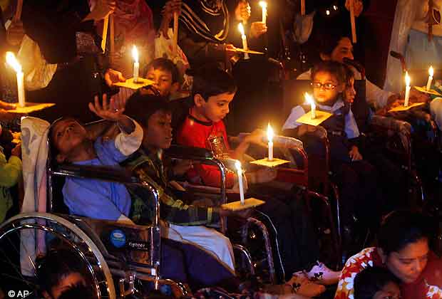 Children born with congenital disease, second generation victims of the1984 Bhopal gas tragedy, participate in a candle light vigil to pay homage to the people killed in the tragedy, in Bhopal, India, Friday, Nov. 30, 2012. The Bhopal industrial disaster killed about 4,000 people on the night of Dec. 3, 1984. The death toll over the next few years rose to 15,000, according to government estimates. A quarter century later, many of those who were exposed to the gas have given birth to physically and mentally disabled children. (AP Photo/Rajeev Gupta)
