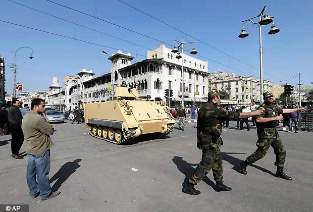 Egyptian Army deploy near the presidential palace to secure the site of overnight clashes between supporters and opponents of President Mohammed Morsi in Cairo, Egypt, Dec. 6, 2012. The Egyptian army has deployed tanks outside the presidential palace in Cairo following clashes between supporters and opponents of Mohammed Morsi. (AP Photo)