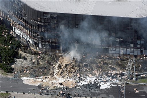 In this aerial view, smoke billows from a seven story building after a small private plane crashed into a building that houses an office of the federal tax agency in Austin, Texas on Thursday Feb. 18, 2010. (AP Photo/Austin American Statesman, Alberto Martinez)
