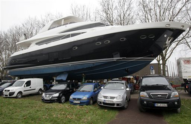 A huge truck drives the Yacht Princess 98, after it was lifted out of the river Rhine in Duesseldorf, Germany, Monday, Jan. 7, 2013. The yacht with it's 30 meter (98ft) length, 95 tons weight and a price of 5.5 million British pounds (8.8 million US dollars, 6.75 million euro) arrives today for the upcoming International Boat fair that lasts from Jan. 19 until Jan. 27,2013. (AP Photo/Frank Augstein)